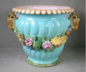 Coloured lead glazes majolica, flowers moulded in high relief. Shape first shown at the 1851 Exhibition by Minton & Co., Exhibit Number 60.