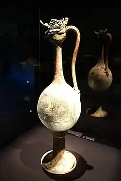 A monumental ewer with incised floral lozenges and cloud designs, made of glazed stoneware with copper-green splashes over a white slip; likely from the Gongxian kilns, Henan