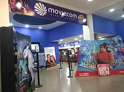 Movie posters flank a Moviecom sign.