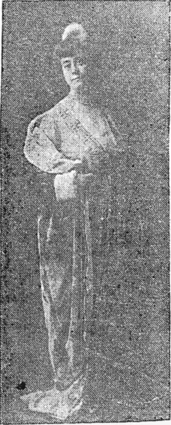B&W photo of a standing middle-aged woman wearing a formal dress, with her hair in an up-do