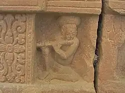 A detail from the Mỹ Sơn E1 pedestal shows a flutist playing his instrument.