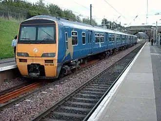 Two trains parked on two platforms. The photo is of the last vehicles of two trains next to each other.