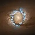 Ring of star birth, and dust, gas and debris from the galaxy, which are being funneled into the supermassive black hole at its centre. Hubble Space Telescope, 2004