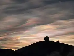 Radome silhouetted by sunlit nacreous clouds, August 2009
