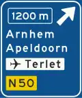 K2: Advance warning sign of a motorway showing the distance to the next exit and destinations after the exit (the top destination is the name of the exit), direction to aerodrome/airport and the road number (non-motorway)(old)