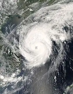 The image shows Typhoon Neoguri near peak intensity on April 17 as a swirling mass of clouds with an eye in the South China Sea. China is visible above the storm.