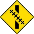 Railway crossing ahead at an oblique angle
