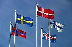 The flags of Denmark, Iceland, Finland, Sweden, and Norway flying on flagpoles