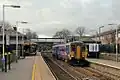 A Northern Rail Class 156 waits at the station.