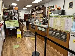 Photograph of the interior of a shop with a counter and many products on display