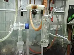 A stopcock in the open position, connected to the oil bubbler via a short hose