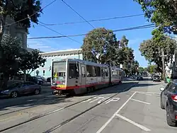An outbound train viewed from the inbound boarding area at Church and 27th Street, 2019