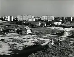 Archive photo showing modern housing in the distance and the Santa Maria Nascente&nbsp;[it] church by Vico Magistretti and Mario Tedeschi (Paolo Monti photograph, 1960)