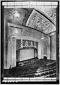 1932 view looking down from the balcony at the ceiling, proscenium, curtain, seating and hydraulic orchestra pit