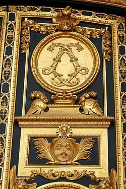 Baroque monogram of Louis XIV made of acanthuses, on the entrance door of the Dôme des Invalides, Paris, designed by Jules Hardouin-Mansart, 1677–1706[10]