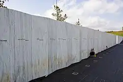 White granite wall with engraved names