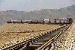 Train running between mountains in Toksun County, Turpan