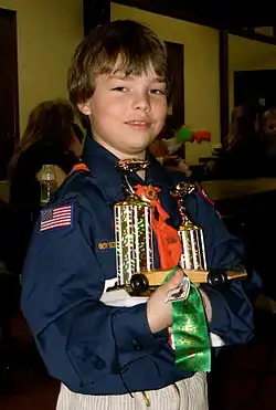 Image 25A happy Cub Scout holds a winning pine car