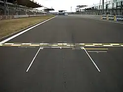 starting box on racetrack, with checkered starting and finishing line in front