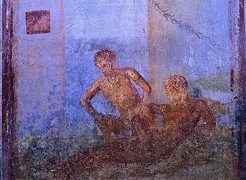 A female is sitting on a male's lap, lowering herself on his penis. Wall painting from Pompeii, 1st Century CE