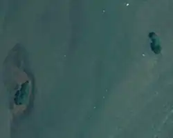 An aerial photograph of two small islands separated by water