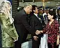 Filipino President Gloria Macapagal Arroyo shakes hands with the Libyan Chargé d'affaires prior to leaving for Tripoli to attend the parade.