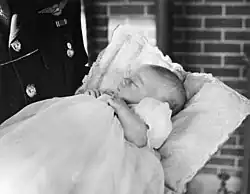 Infant held in gown and blanket