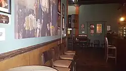 Photograph of the interior of a bar with various seats