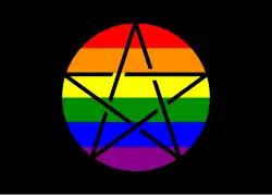 Rectangular flag with black background. A circumscribed pentagram (known as a pentacle) with black lines and a LGBTQ rainbow background sits in the center.