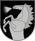 A coat of arms depicting a silver horse that is rearing and neighing all on a dark green background bordered by a thin silver line
