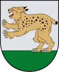 A coat of arms depicting a golden lynx with black spots, a red tongue, white teeth, and white claws standing on its back paws on green turf