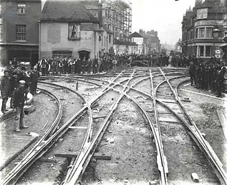 The cross-over at the junction of Broad Street, St. Mary's Butts, Oxford Road and West Street, looking westwards along Oxford Road, 1903. The rails are in place, but not yet filled in with cobble-stones.