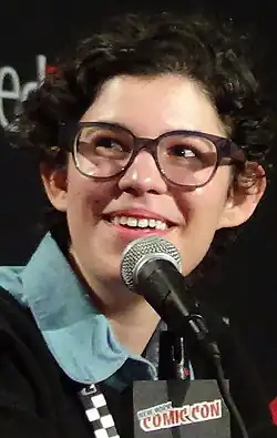Rebecca Sugar, a smiling, bespectacled young individual