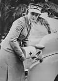 A Red Cross worker refueling a car (1943)