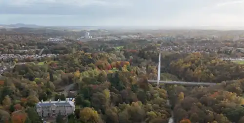 Aerial view looking towards Glenrothes from above the grounds of Leslie House with the cable stayed White Bridge crossing the river valley
