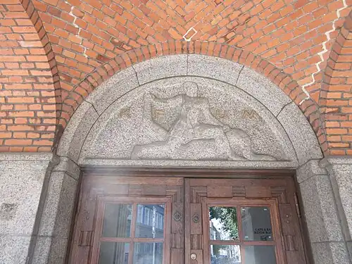 Relief above the main entrance in the arcade.