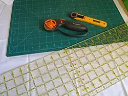 Rotary cutter on a mat being used for sewing and cutting purposes