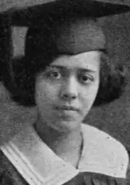 The face of a young African-American woman wearing a cap and gown.