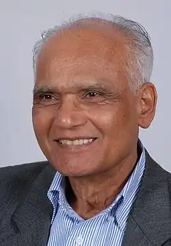 A photograph of a smiling old man.