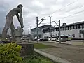 The monument and the railway station entrance in 2016.