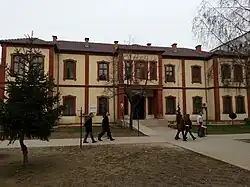 Two-story building with people walking past