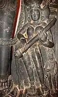 Bengal, India. 11th century C.E. Saraswati playing Eka-tantri vina. Her left hand is holding a stick, which may be like the slide on a Pinaka veena. That stick is not uncommon in the Pala Empire made sculptures. The gourd is resting over her shoulder.