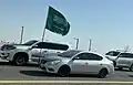 Saudi national flag mounted in front of a Nissan Sunny, 2024