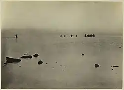 Bathers wading out to the wreckage of Watson's Biplane, off Point Cook, March 1917.