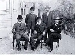 Photo of five men in hats.
