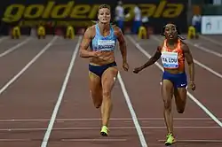 Ta Lou to the right of Dafne Schippers towards the end of a 100 metre race