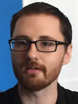 Headshot of Evan Amos in an interview with the Wikimedia Foundation. He is a middle-aged white man with glasses wearing a dark-colored shirt.