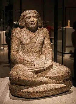 Seated portrait statue of Dersenedj, scribe and administrator; c. 2400 BC; rose granite; height: 68&nbsp;cm; from Giza; Egyptian Museum of Berlin