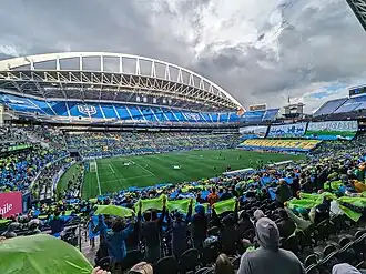 The field and surrounding seats with pre-game pageantry on the field.