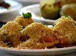 Yellow bits of sev on sev puri